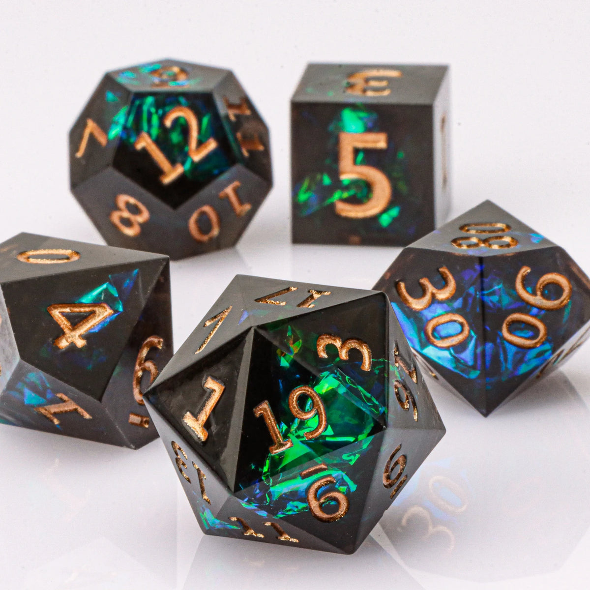 A set of handmade resin polyhedral dice in various colors and shapes, including a d10, d5, and d20.