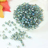 A pile of multicolored faceted glass crystal beads in various sizes and shapes for jewelry making