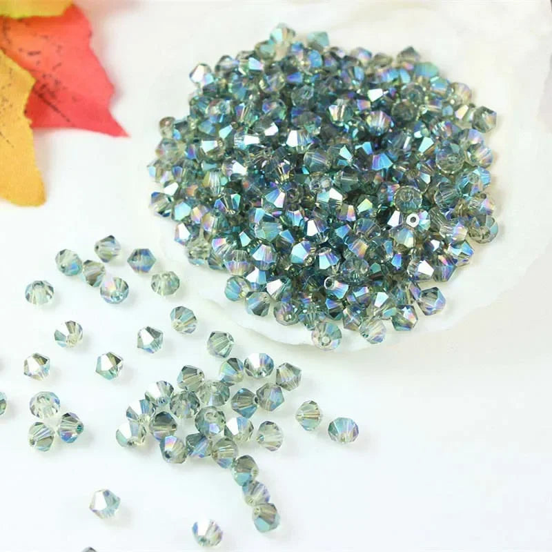 A pile of multicolored faceted glass crystal beads in various sizes and shapes for jewelry making