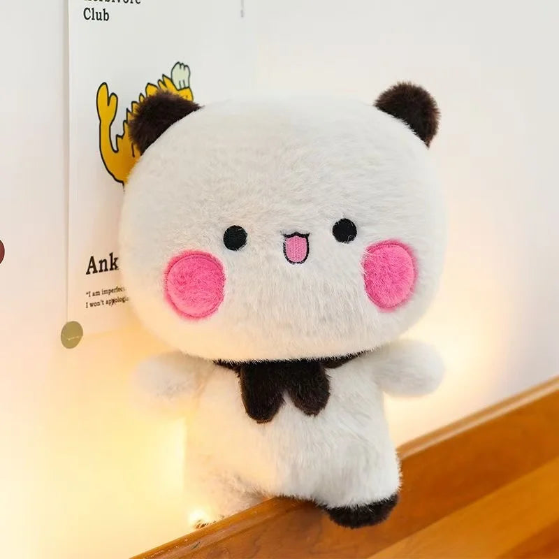 A white and black panda plush set featuring a cute, round stuffed animal with pink accents.