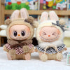 A pair of fluffy rabbit dolls with pink ears and decorative bows, resembling a retro grid cape and beret set.