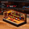A wooden building block set depicting a retro car repair shop with various tools and miniature cars.