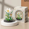 A white building block set of eternal flower garden with a dust cover displayed next to its packaging box.