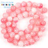 A collection of pink and clear natural sea sediment jasper and turquoise beads for jewelry making