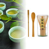 A set of traditional bamboo matcha whisks and a glass container for tea ceremony