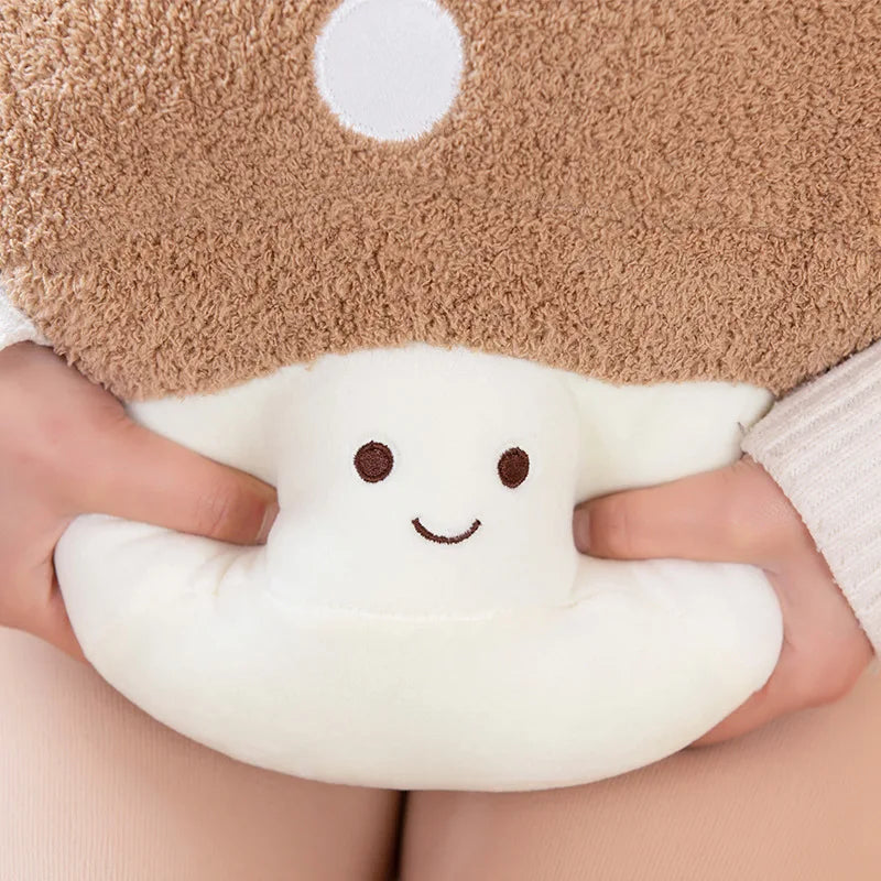 A hand is holding a white mushroom plush toy with brown eyes and a fuzzy beige background.