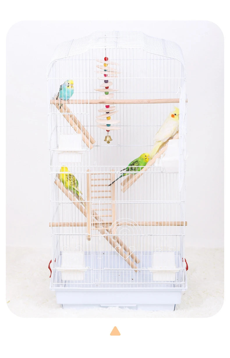 A white bird cage with a wooden climbing ladder and various toys inside for parrot play.