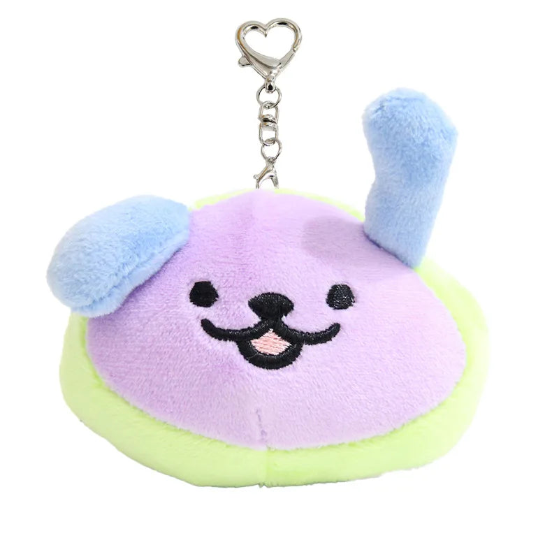 A purple and light green plush pendant doll with blue ears and a silver chain.