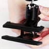 A hand holds a black 360° rotating guitar phone mount for live streaming and recording.