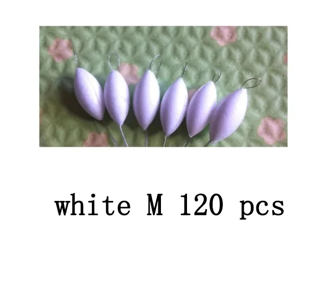A close-up photo of 120 white oval fishing floats with bobber beads on a green background.