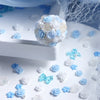 A cluster of blue and white camellia resin flowers used as shaker fillers for DIY crafts.
