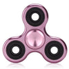 A close-up view of a rose gold aluminum alloy fidget spinner with precision bearings.