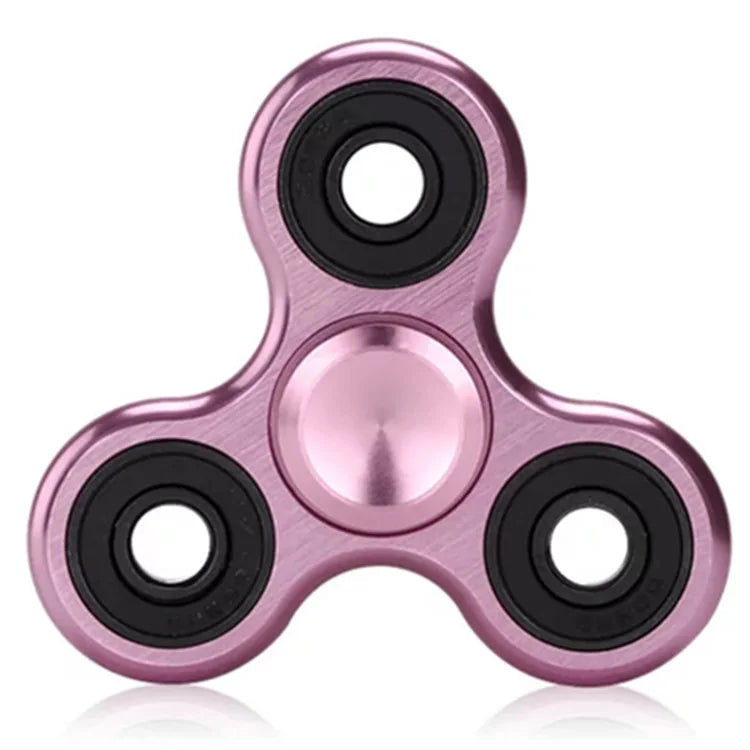 A close-up view of a rose gold aluminum alloy fidget spinner with precision bearings.
