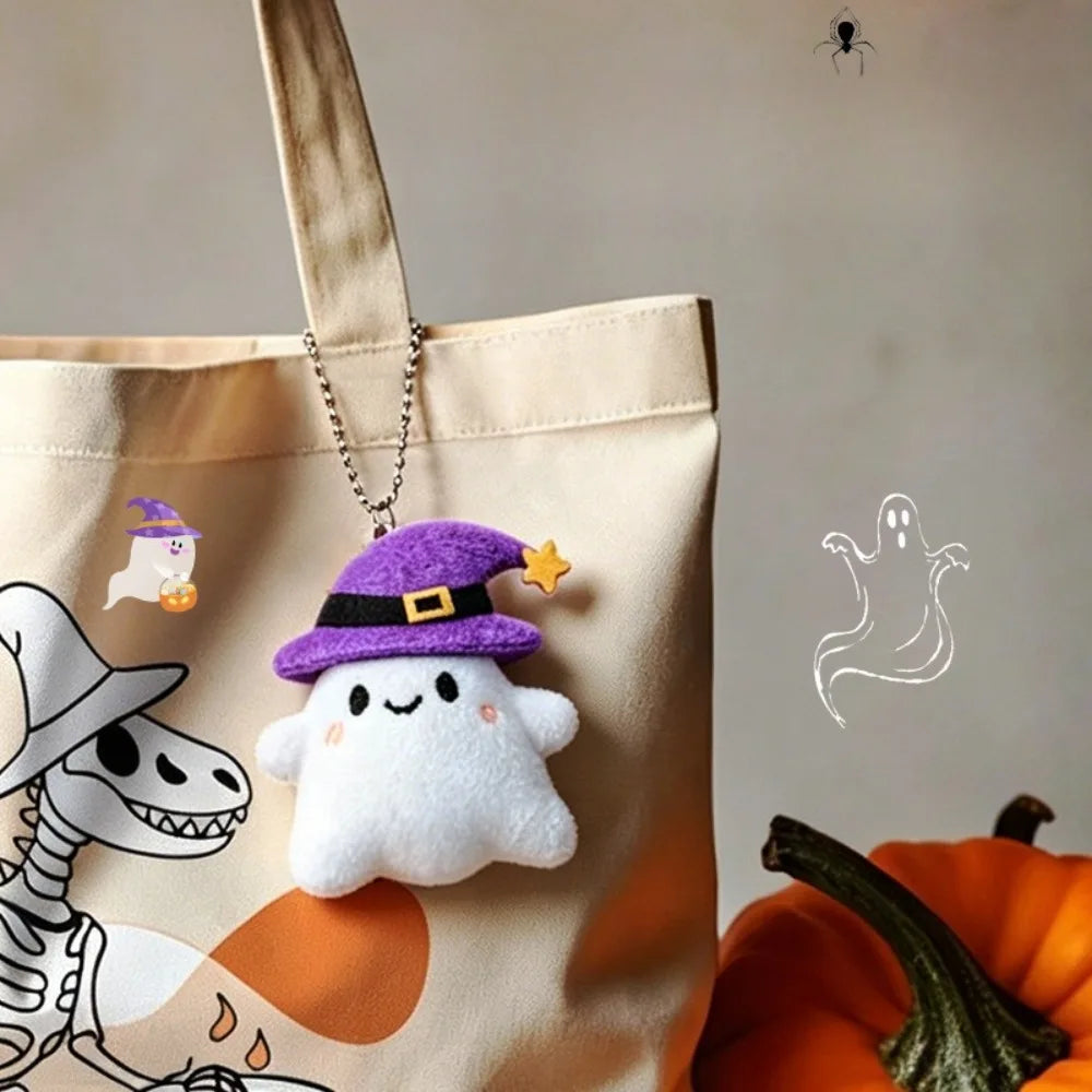 A beige tote bag features a Halloween plush keychain set including a purple witch hat ghost and other charms.