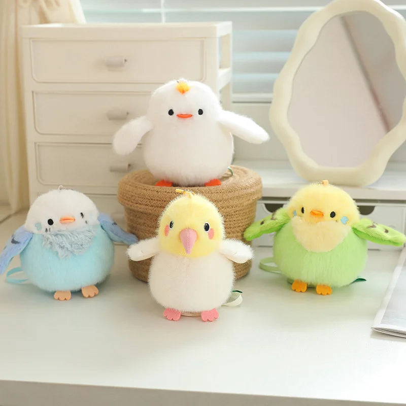 A collection of soft, fluffy cartoon bird plush toys in white, yellow, and green sitting on a white desk next to a mirror.