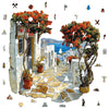 A jigsaw puzzle depicting a vibrant outdoor scene with stone walls, potted plants, and flowering trees.