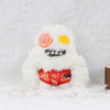 A white fluffy monster plush toy with large eyes and a mouth showing teeth, set against a white textured background.