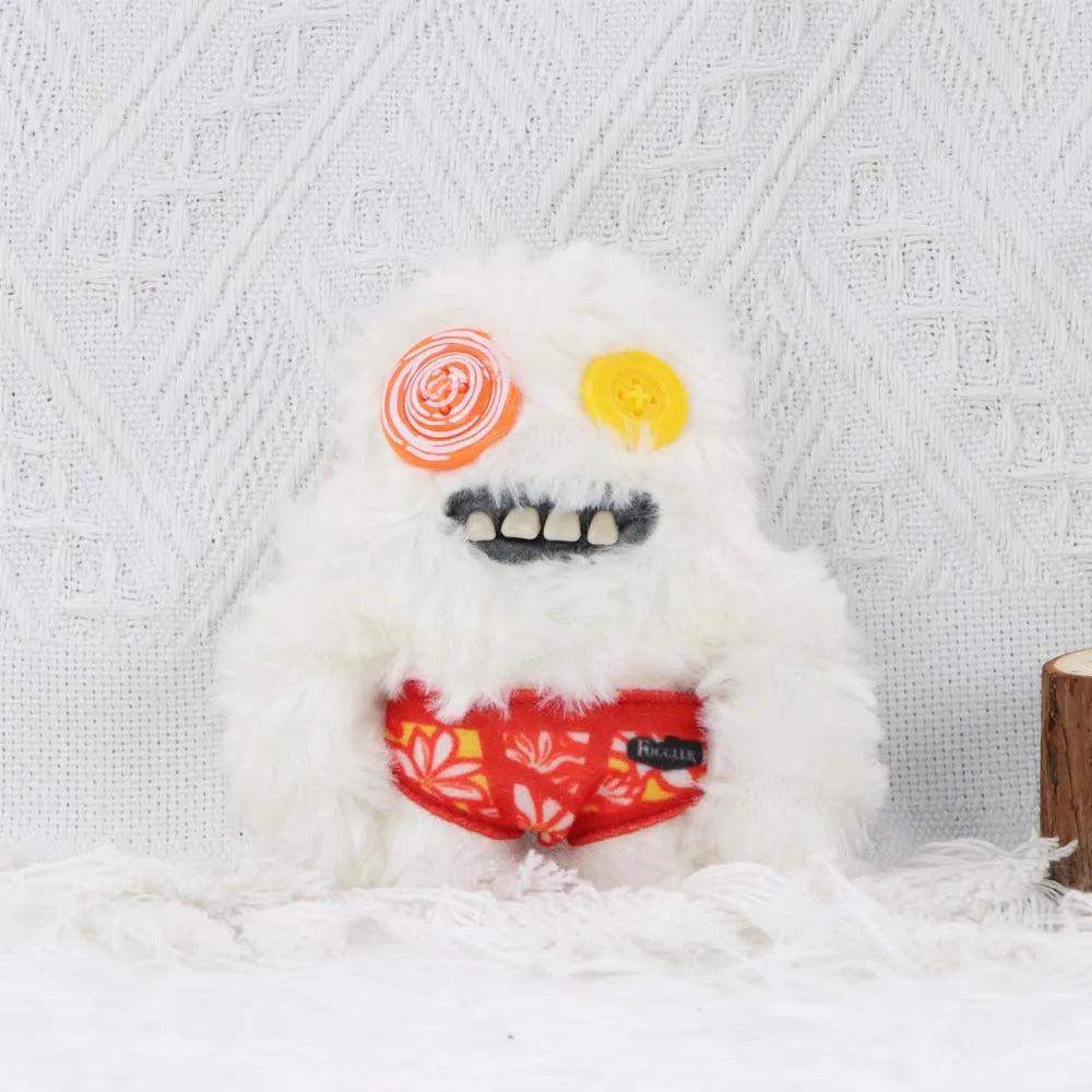 A white fluffy monster plush toy with large eyes and a mouth showing teeth, set against a white textured background.