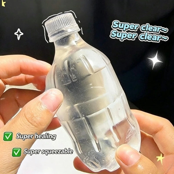 A clear plastic bottle shaped like a stress ball is being held by a hand, with text indicating super healing and squeezabilit