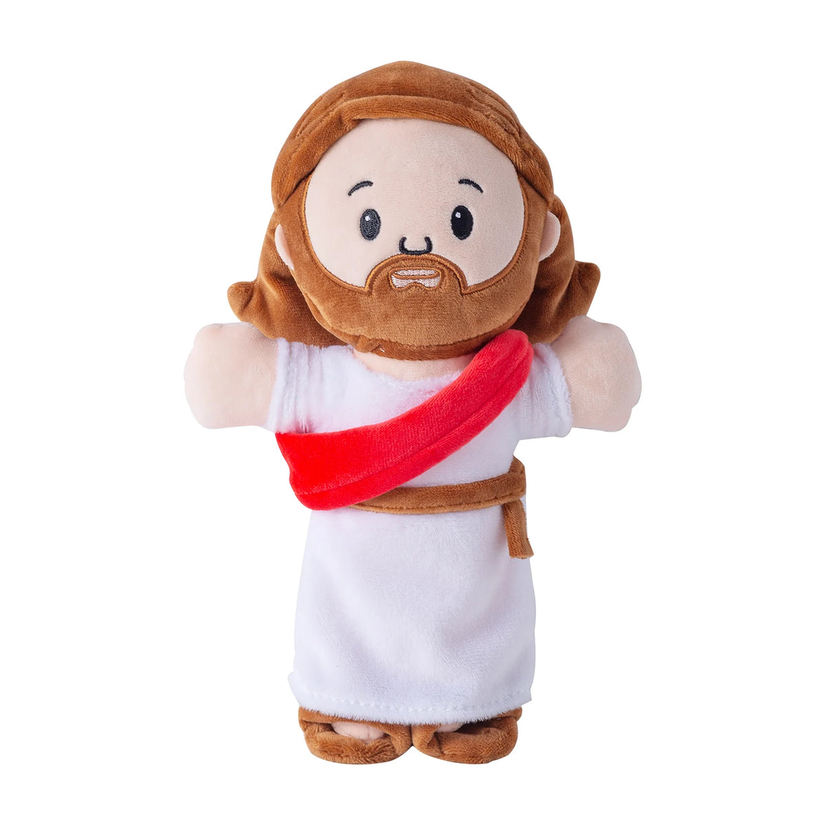 A plush toy of Jesus with brown hair and beard wearing a white robe and a red sash.