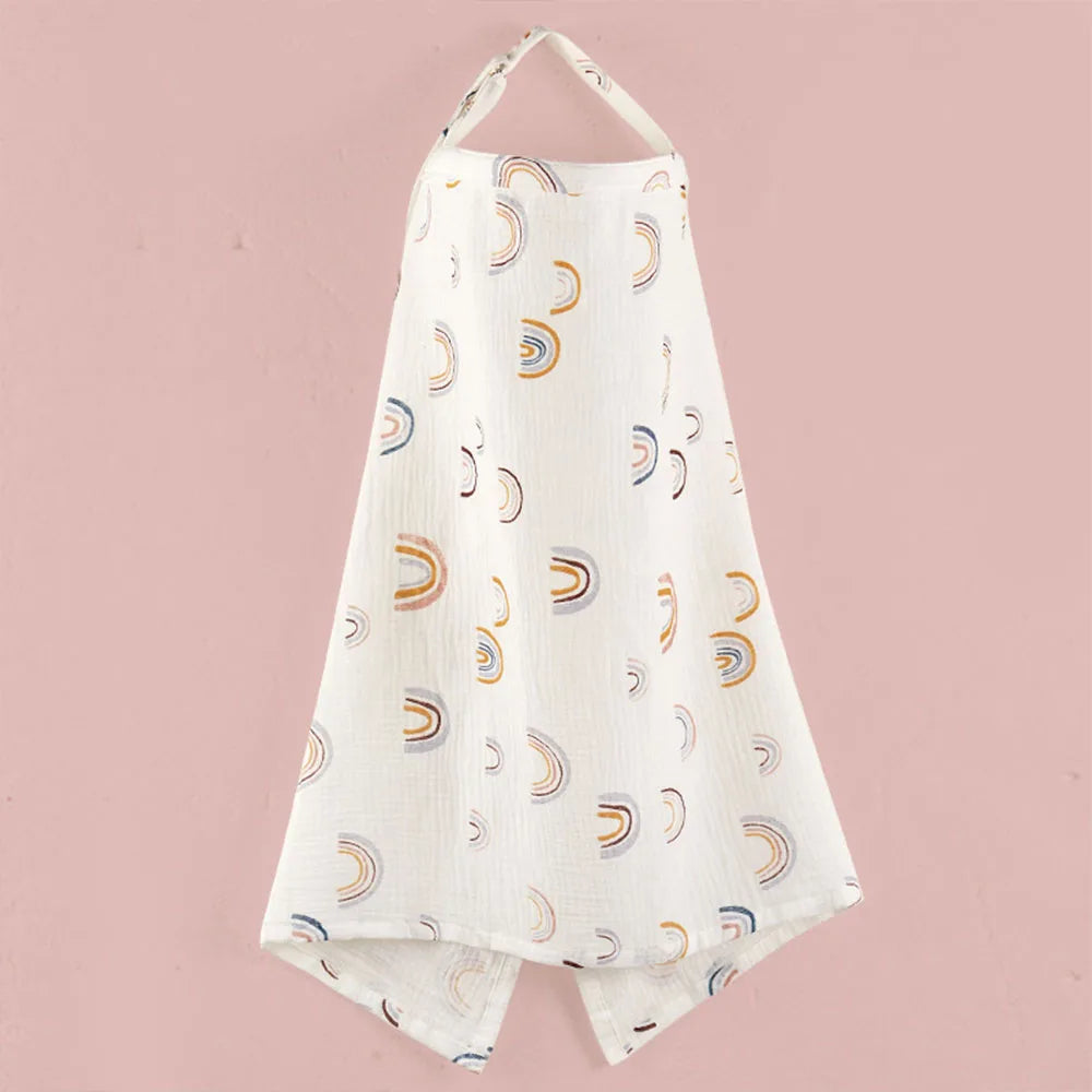 White breathable muslin nursing cover with a subtle rainbow pattern