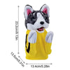 A yellow puppet resembling a husky dog with black and white fur and pink inner ears.