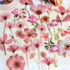 A collection of 50 transparent pink and purple floral PET stickers for journals and crafts.