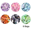 Six circular displays of various colored acrylic beads and stones for DIY jewelry making