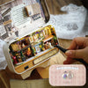 A wooden miniature dollhouse theater kit featuring a detailed scene of a shop and street.