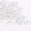 Clear glass star spacer beads with iridescent blue and yellow accents for jewelry making