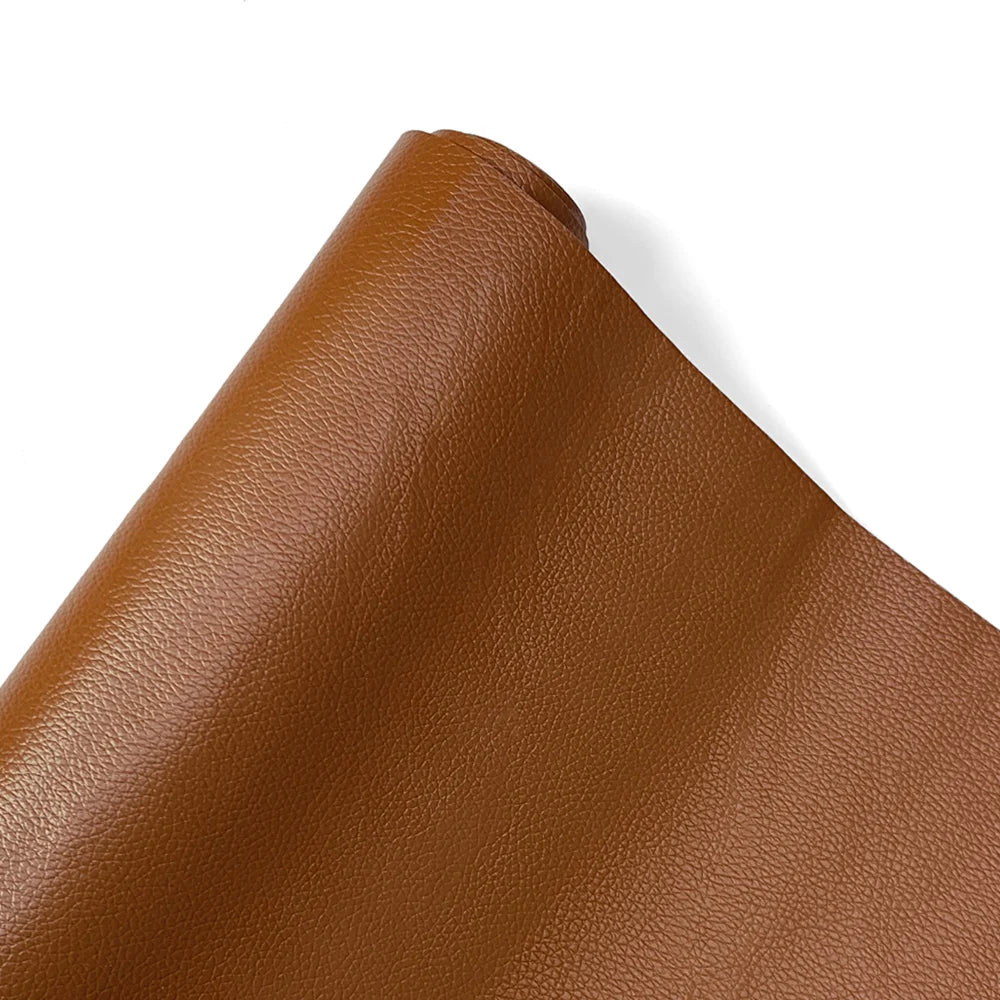 A close-up view of a brown PU leather self-adhesive repair patch rolled up.