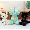 A collection of Toothless Dragon plush toys in various colors and poses displayed on a white surface.