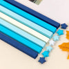 A collection of blue, teal, and white rectangular strips and star shapes for DIY crafting