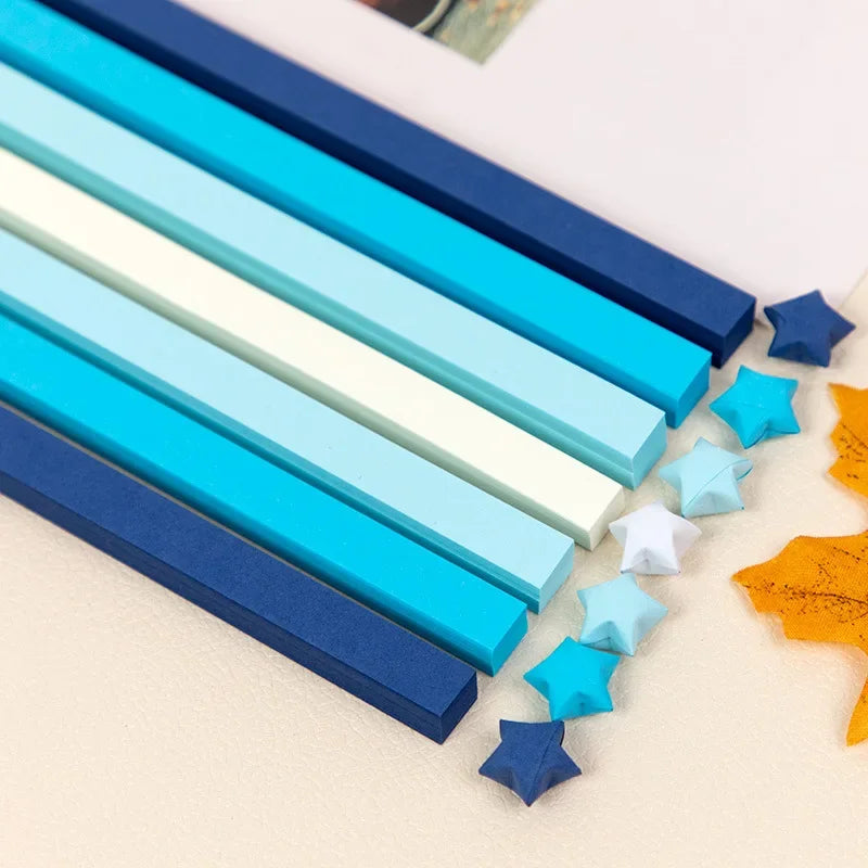 A collection of blue, teal, and white rectangular strips and star shapes for DIY crafting