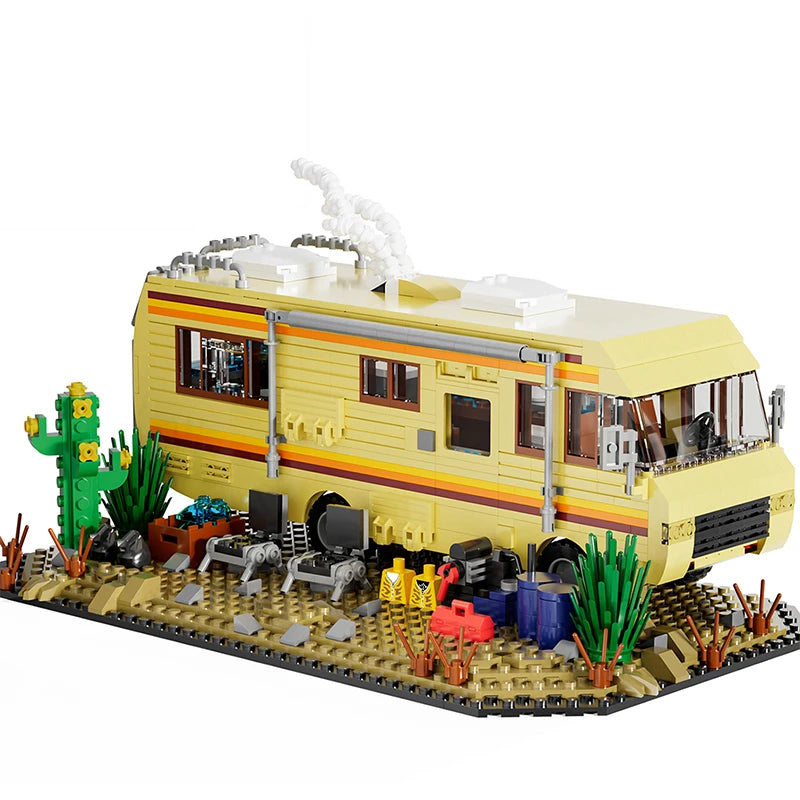 A detailed building block set depicting a yellow RV camper bus with cacti and landscaping.