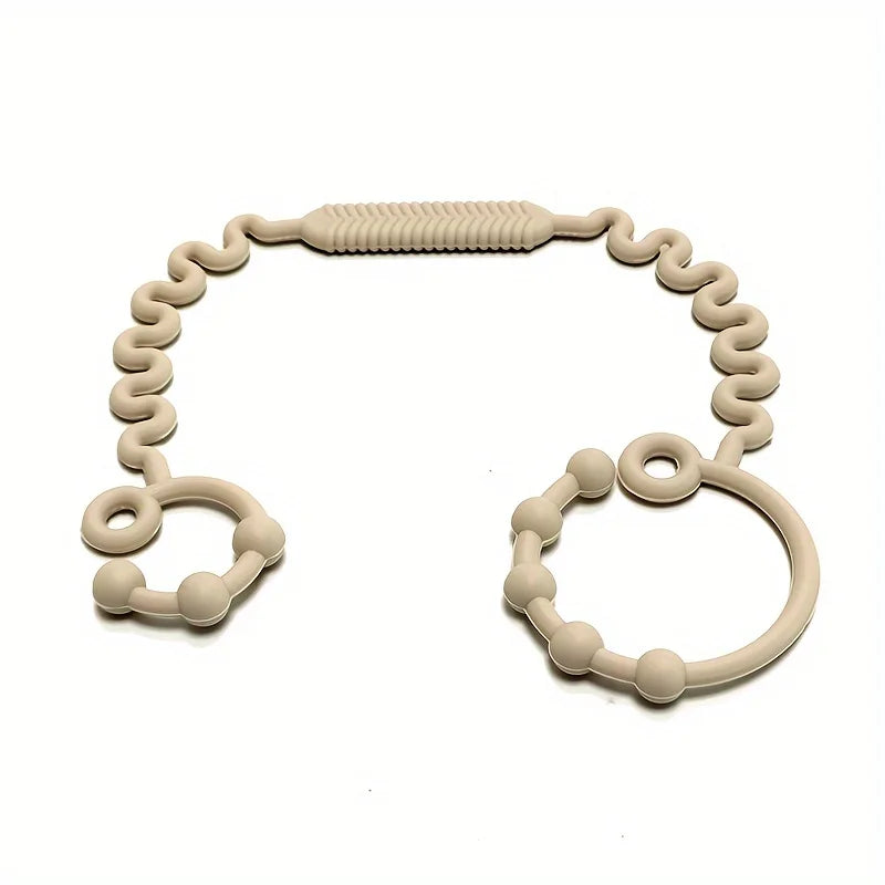 Pacifier anti-chute en silicone en forme d'anneau avec un dessus texturé.
