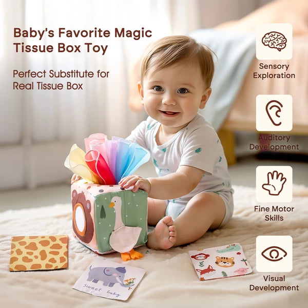 A baby is playing with a colorful tissue box toy designed for sensory exploration and fine motor skill development.