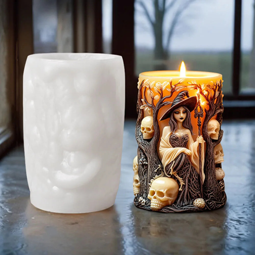 A lit silicone candle mold shaped like a witch portrait with skulls and trees sits on a dark surface.