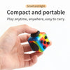A hand holds a colorful fidget cube with multiple buttons, demonstrating its compact and portable design.