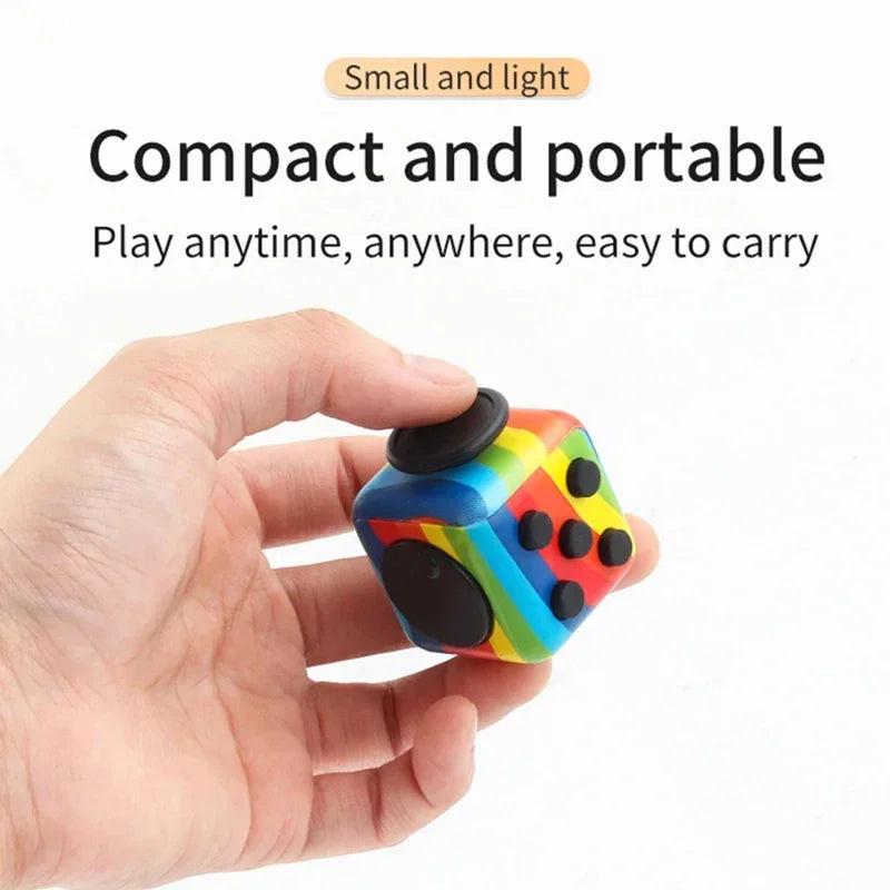 A hand holds a colorful fidget cube with multiple buttons, demonstrating its compact and portable design.