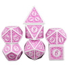 A set of pink and white polyhedral dice including a tetrahedron, octahedron, dodecahedron, and icosahedron.