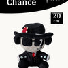 A black plush toy resembling a cowboy hat and sunglasses with red accents, displayed against a white background.