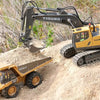 A yellow YIGONG excavator truck with a hydraulic arm is shown on a pile of dirt.