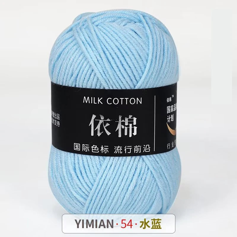 A ball of light blue milk cotton yarn labeled YIMIAN 54 with Chinese characters for knitting and crochet.