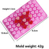 A pink silicone mold set shaped like a diamond with multiple heart-shaped cavities for candle making or crafting.