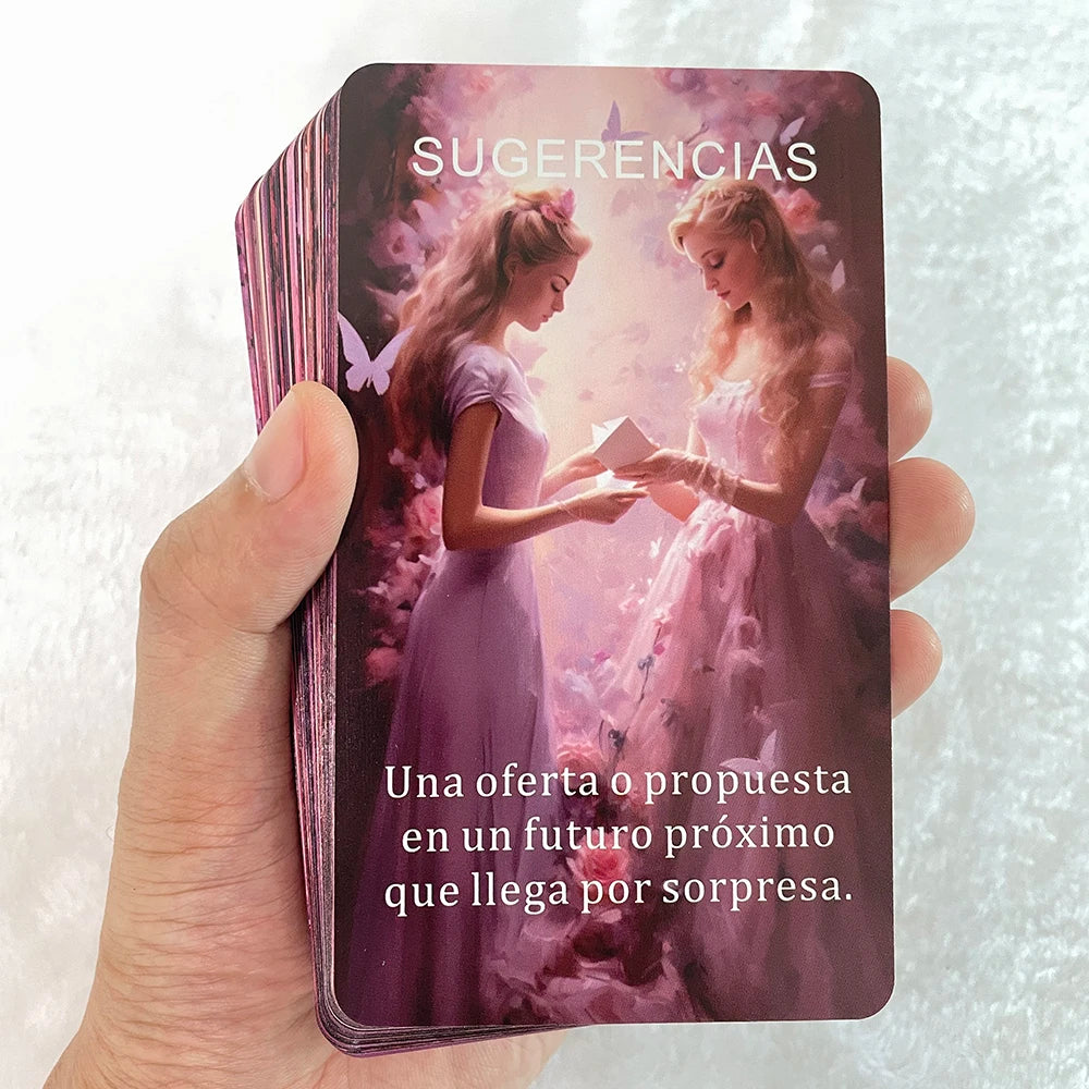 A hand holds a purple oracle card featuring two women in gowns and the text Sugerencias