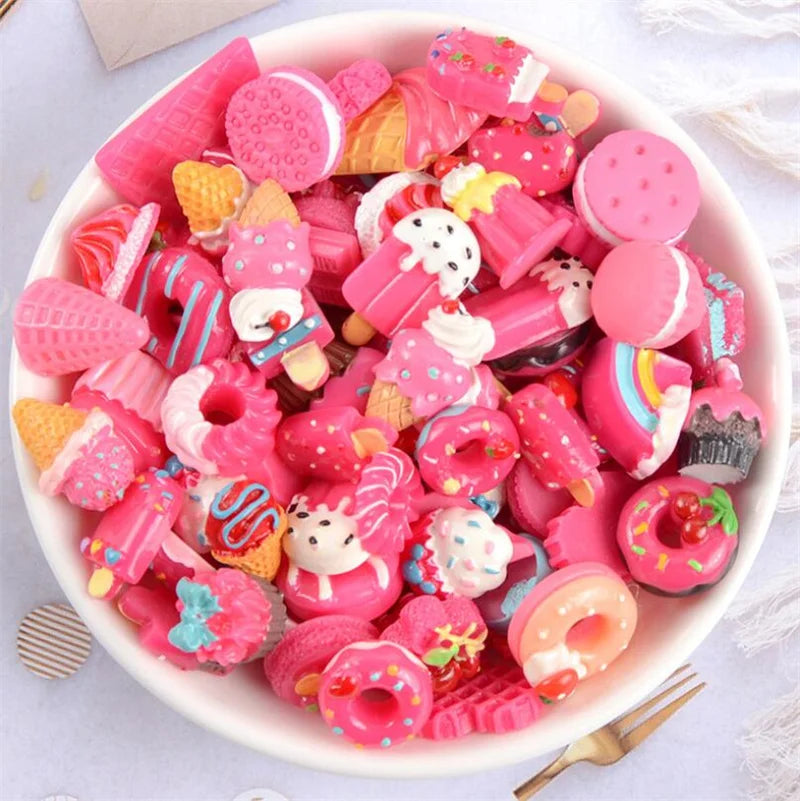 A bowl filled with assorted pink and colorful candy resin flatbacks for DIY crafts and jewelry making