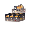 A box of Snoopy Mischief Party Series collectible figures featuring dog characters and themed packaging.