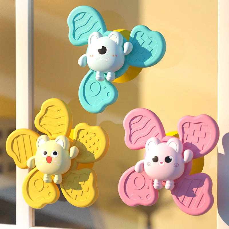 A set of three suction cup spinner bath toys for babies featuring cute animal shapes in light blue, yellow, and pink.