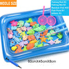 A blue plastic tray filled with colorful magnetic fishing rods, nets, and fish for a kids' fishing game.